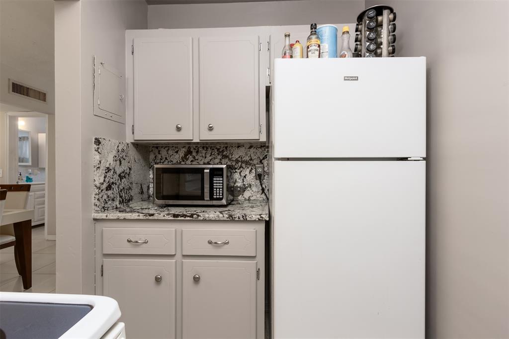 350 South Cypress Road, Unit 522 Pompano Beach, FL 33060 - Photo 22 of 27 a white refrigerator freezer sitting inside of a kitchen