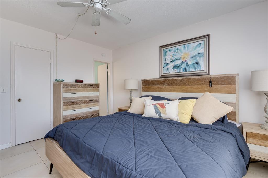 350 South Cypress Road, Unit 522 Pompano Beach, FL 33060 - Photo 27 of 27 a bedroom with a bed and a chandelier