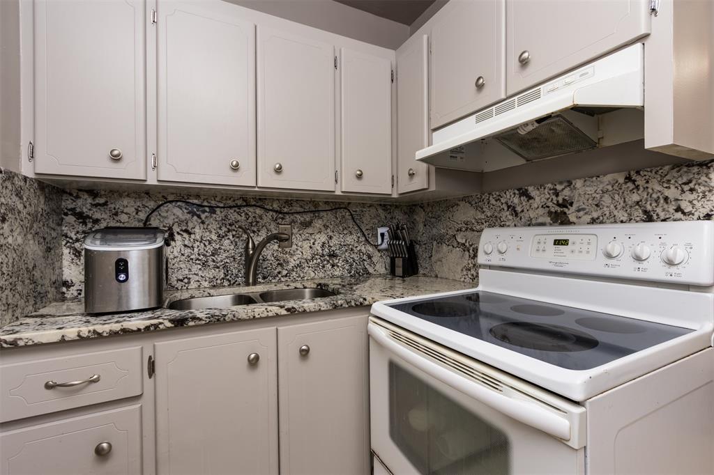 350 South Cypress Road, Unit 522 Pompano Beach, FL 33060 - Photo 3 of 27 a kitchen with granite countertop white cabinets and white appliances