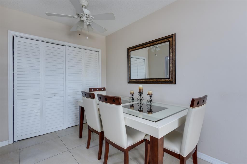 350 South Cypress Road, Unit 522 Pompano Beach, FL 33060 - Photo 5 of 27 a dining room with a table and chairs