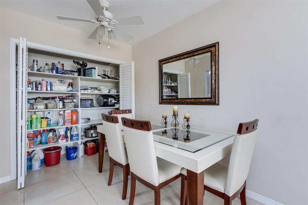350 South Cypress Road, Unit 522 Pompano Beach, FL 33060 - Photo 6 of 27 a view of a dining room with a table and chairs