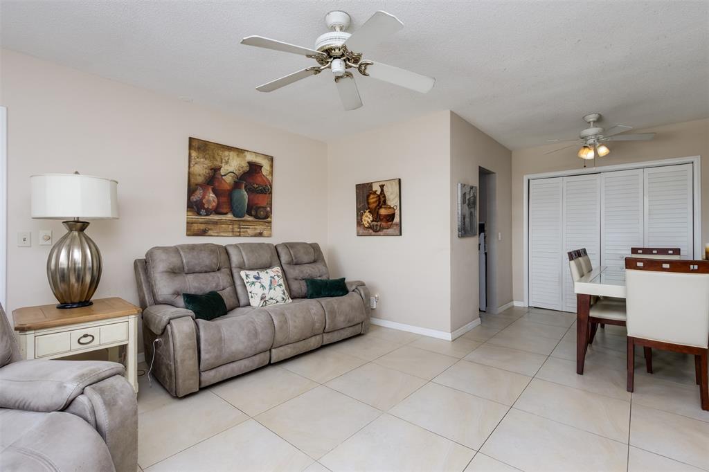 350 South Cypress Road, Unit 522 Pompano Beach, FL 33060 - Photo 8 of 27 a living room with furniture and a chandelier