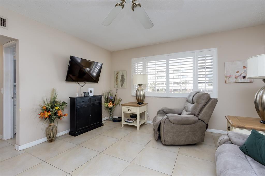 350 South Cypress Road, Unit 522 Pompano Beach, FL 33060 - Photo 10 of 27 a living room with furniture a flat screen tv and a window