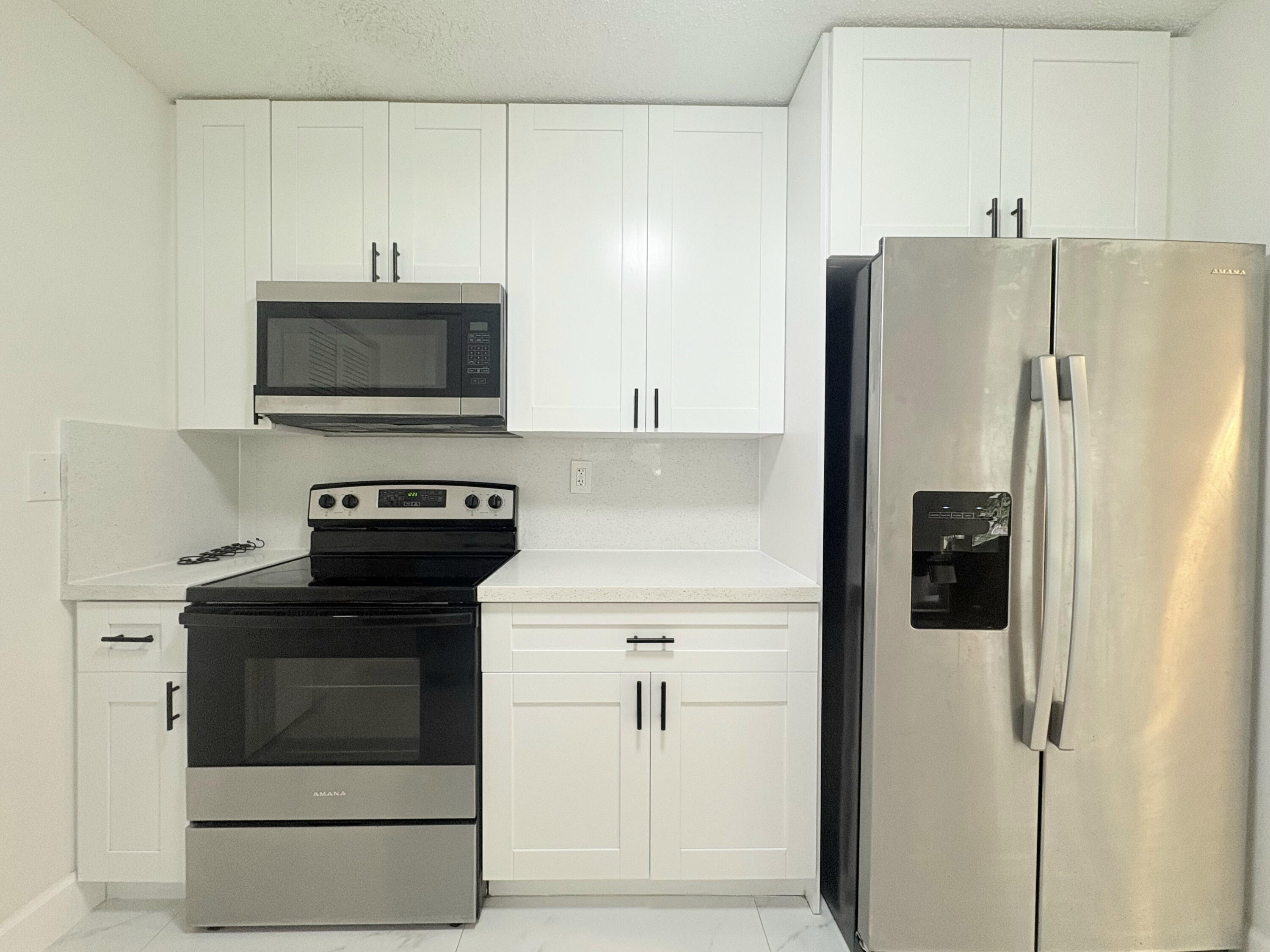 14523 Flamingo Road Loxahatchee Groves, FL 33470 - Photo 12 of 50 a kitchen with a refrigerator and a stove