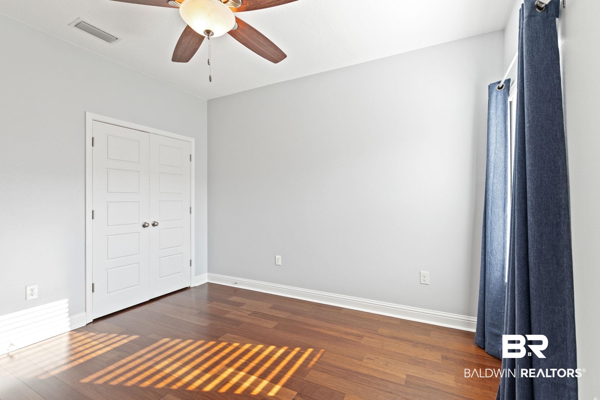 31541 Hoot Owl Road Daphne, AL 36527 - Photo 35 of 51 Unfurnished bedroom with dark hardwood / wood-style floors and ceiling fan