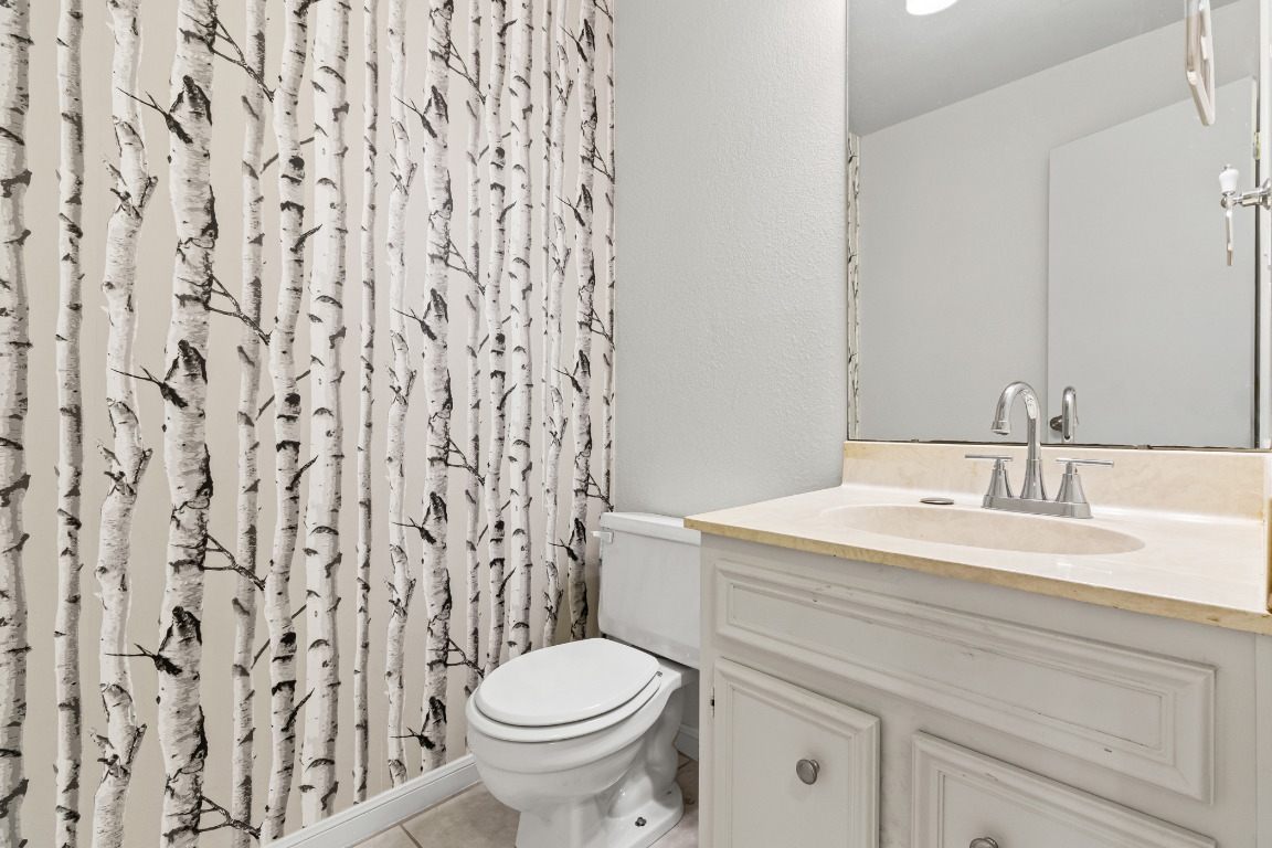 8113 Baywood Drive, Unit A Austin, TX 78759 - Photo 12 of 29 a bathroom with a granite countertop sink and a toilet