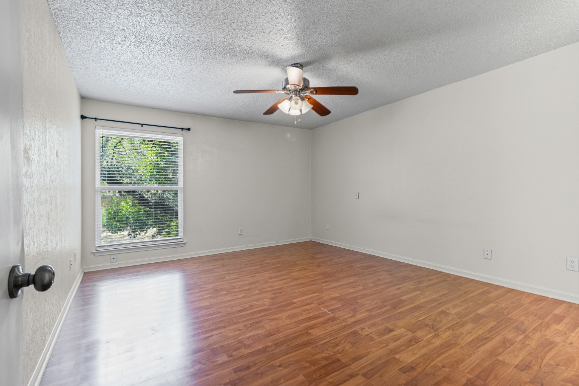 8113 Baywood Drive, Unit A Austin, TX 78759 - Photo 13 of 29 wooden floor in an empty room with a window