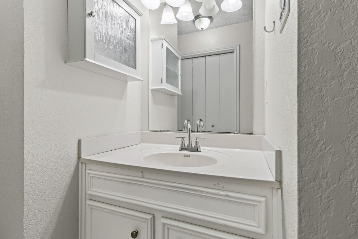 8113 Baywood Drive, Unit A Austin, TX 78759 - Photo 15 of 29 a bathroom with a sink and a mirror