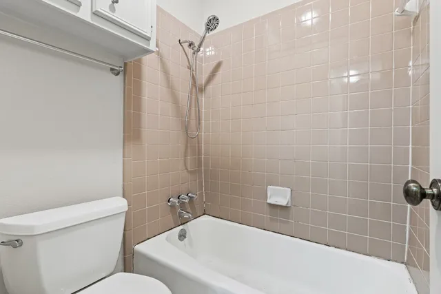 a bathroom with a toilet and shower