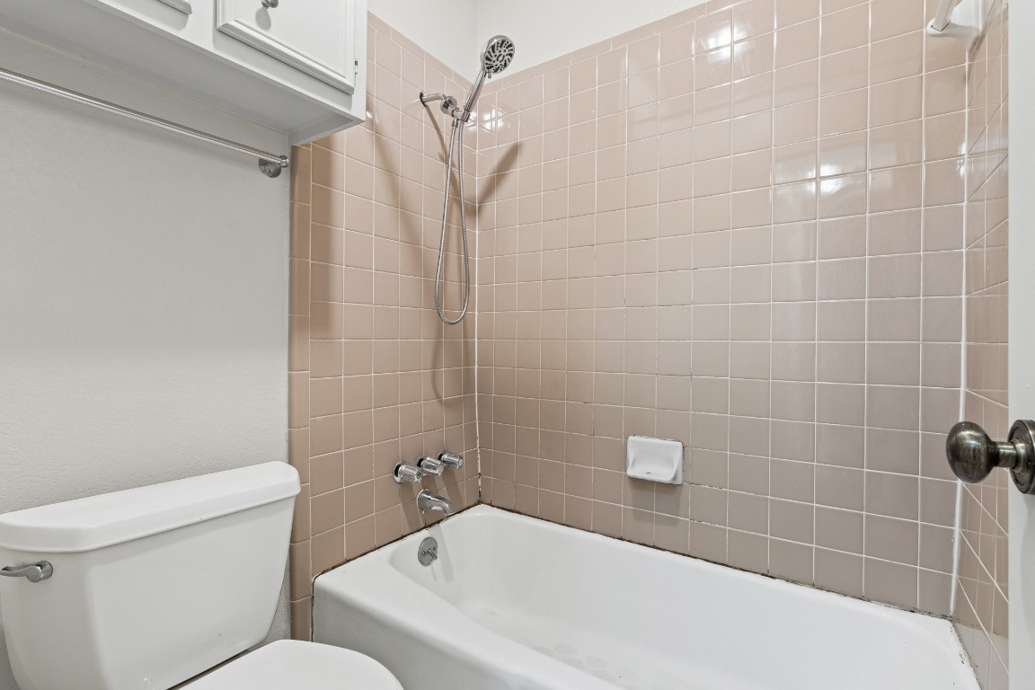 8113 Baywood Drive, Unit A Austin, TX 78759 - Photo 17 of 29 a bathroom with a toilet and shower