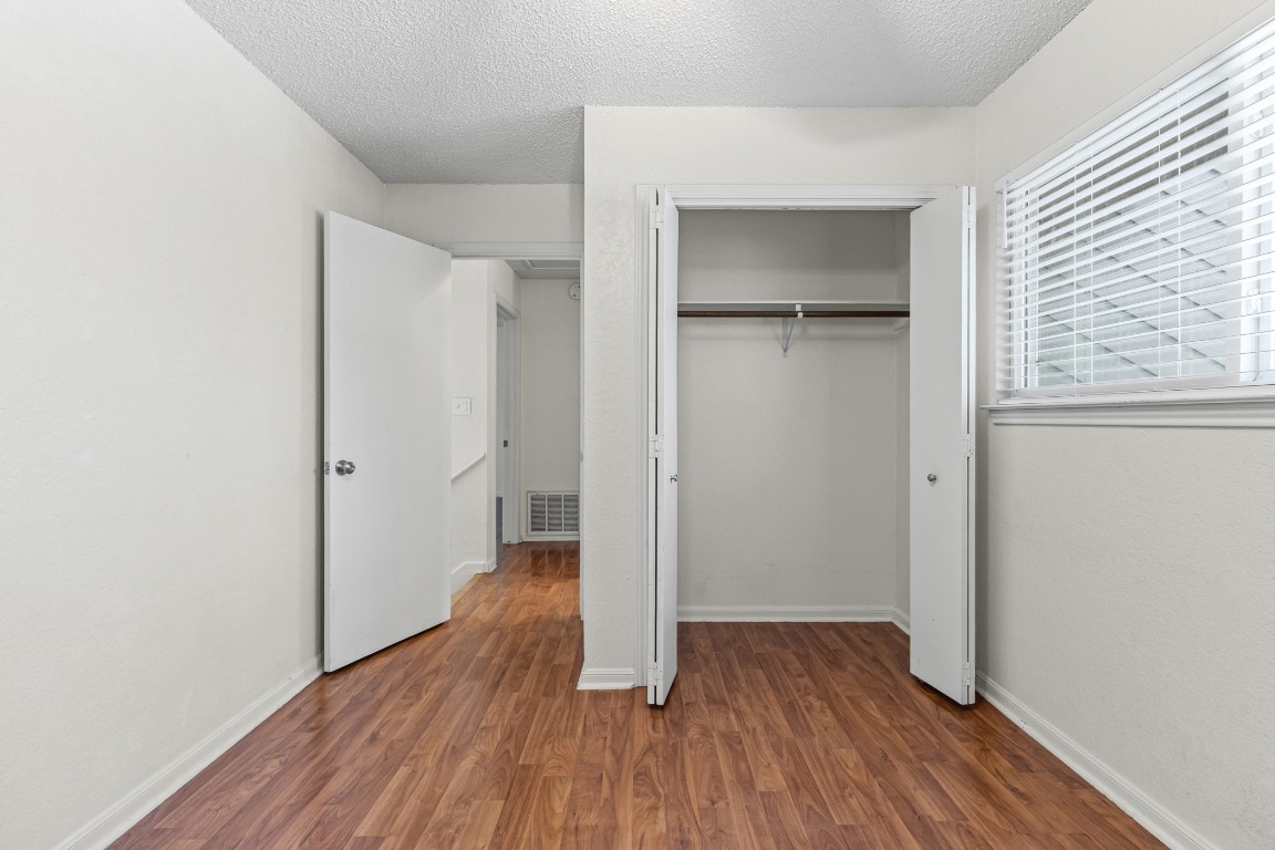 8113 Baywood Drive, Unit A Austin, TX 78759 - Photo 19 of 29 an empty room with wooden floor and a window