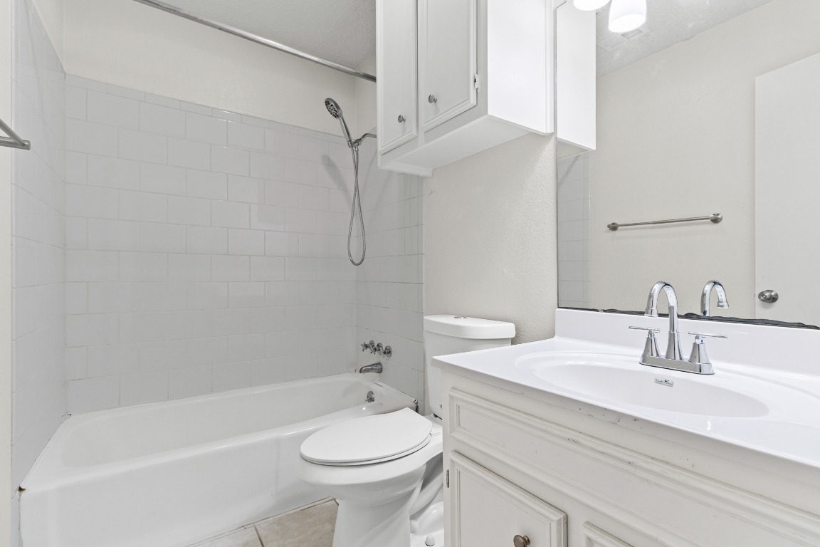 8113 Baywood Drive, Unit A Austin, TX 78759 - Photo 20 of 29 a bathroom with a sink a toilet and a bathtub