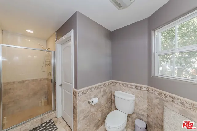 a bathroom with a toilet sink and shower