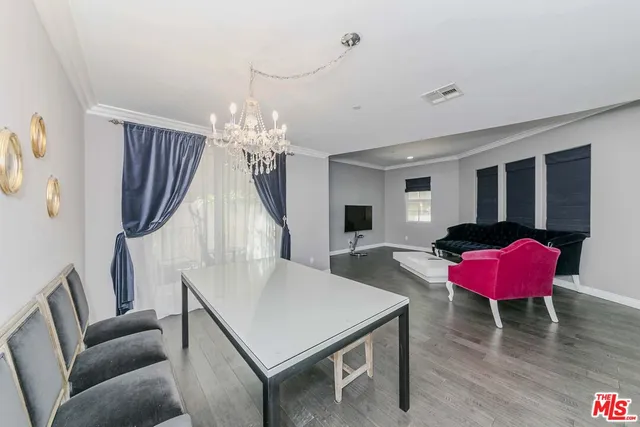 a living room with furniture a table and a chandelier