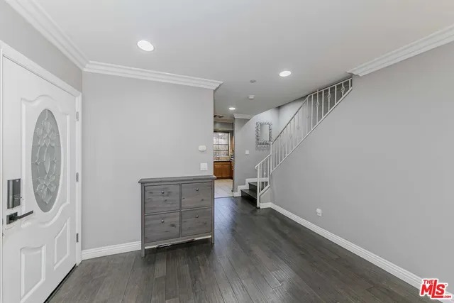a view of a livingroom with wooden floor and furniture