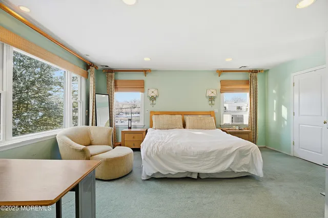 a bedroom with a bed and glass window