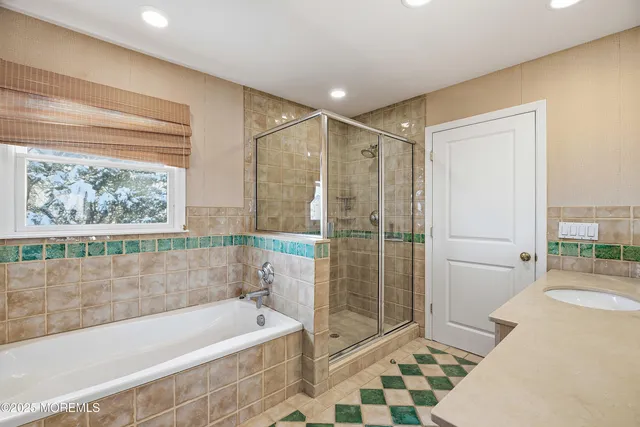 a bathroom with a bathtub and a shower