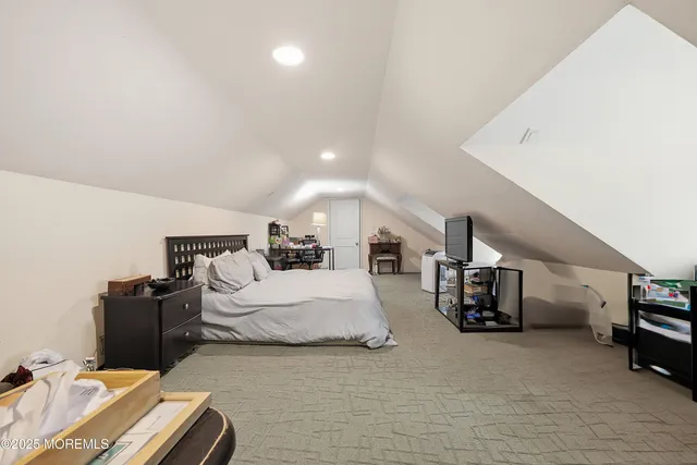 a spacious bedroom with a bed and a couch