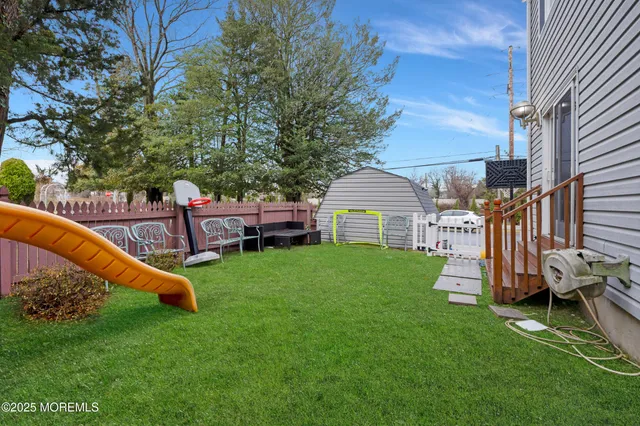 a view of backyard with deck and garden
