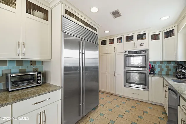 a kitchen with granite countertop stainless steel appliances and counter space