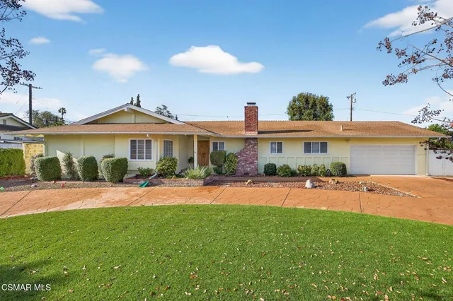 a front view of a house with a yard and porch