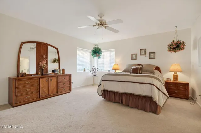 a spacious bedroom with a bed and a dresser
