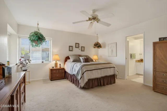 a spacious bedroom with a bed and a chandelier