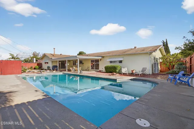 swimming pool view with a seating space
