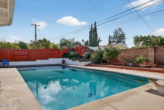 a view of a backyard with sitting area