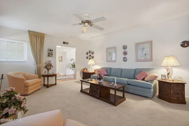 a living room with furniture and a lamp