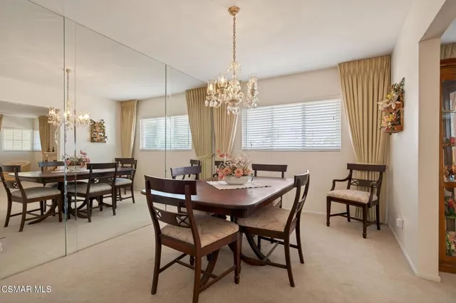 a view of a dining room with furniture and window
