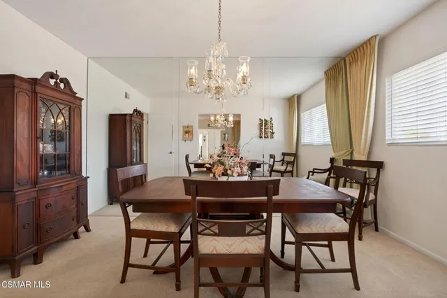 a view of a dining room with furniture and window