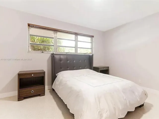 a bedroom with a bed and a television