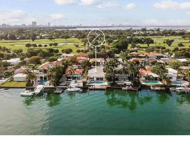 a view of a city with lots of residential buildings ocean and mountain view