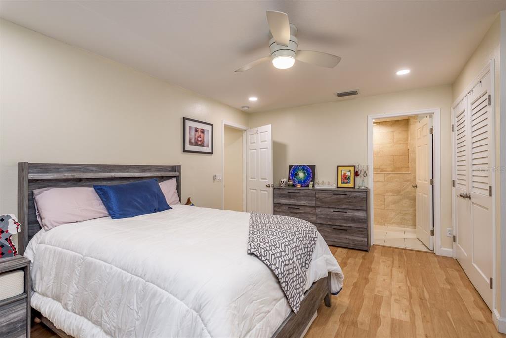 1333 McMullen Booth Road, Unit 1333 Clearwater, FL 33759 - Photo 11 of 26 a bedroom with a bed and a flat screen tv