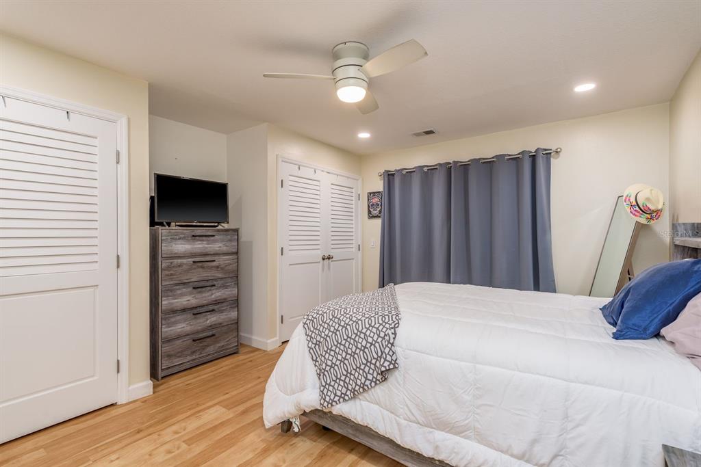 1333 McMullen Booth Road, Unit 1333 Clearwater, FL 33759 - Photo 12 of 26 a bedroom with a bed and a view of closet