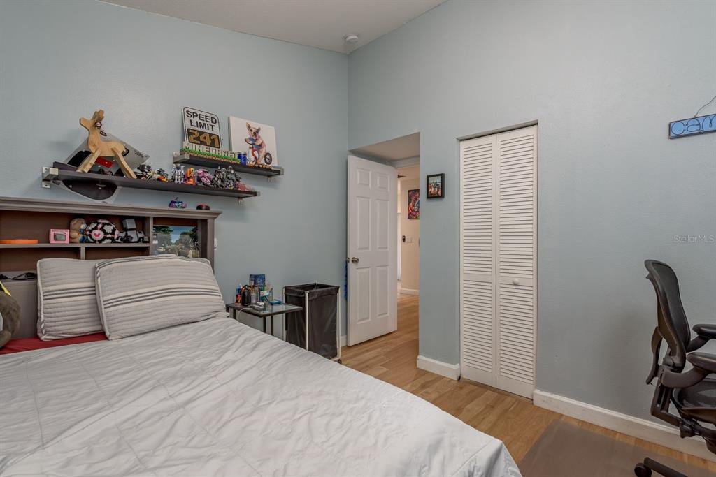 1333 McMullen Booth Road, Unit 1333 Clearwater, FL 33759 - Photo 16 of 26 a bedroom with a bed and wooden floor