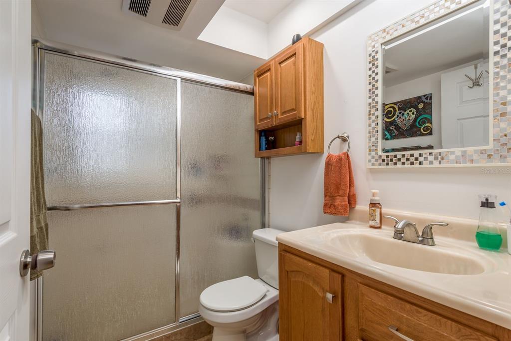 1333 McMullen Booth Road, Unit 1333 Clearwater, FL 33759 - Photo 17 of 26 a bathroom with a granite countertop sink toilet and shower