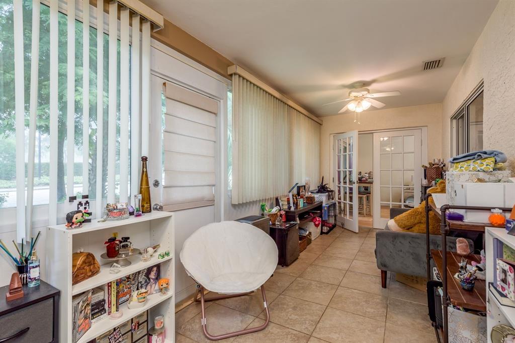 1333 McMullen Booth Road, Unit 1333 Clearwater, FL 33759 - Photo 18 of 26 a room with furniture a rug toys and a window