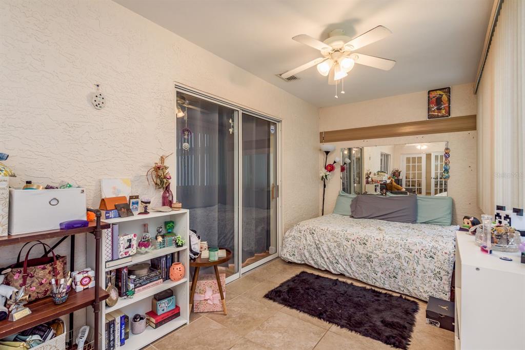 1333 McMullen Booth Road, Unit 1333 Clearwater, FL 33759 - Photo 19 of 26 a bedroom with a bed furniture and a chandelier