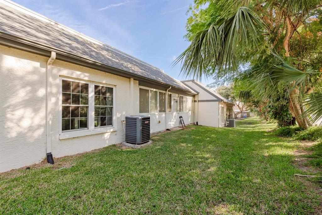1333 McMullen Booth Road, Unit 1333 Clearwater, FL 33759 - Photo 20 of 26 a view of a house with a backyard