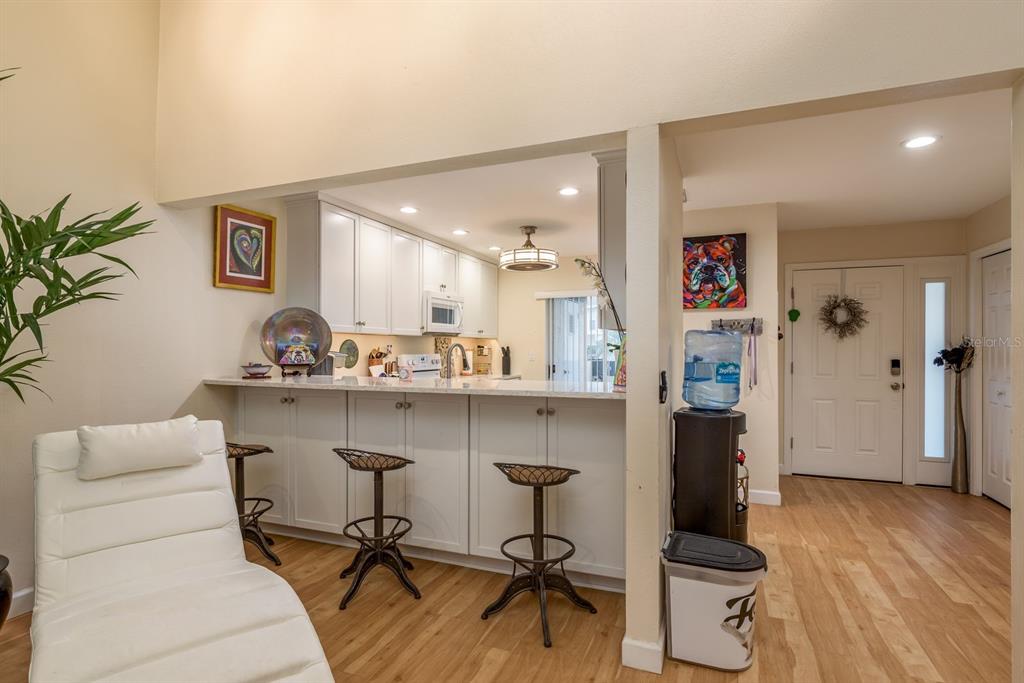1333 McMullen Booth Road, Unit 1333 Clearwater, FL 33759 - Photo 7 of 26 a living room with furniture and wooden floor
