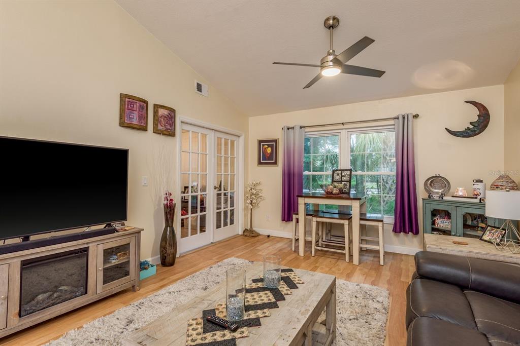 1333 McMullen Booth Road, Unit 1333 Clearwater, FL 33759 - Photo 10 of 26 a living room with furniture a flat screen tv and a fireplace