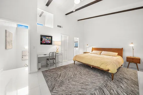 a bedroom with a bed and a table in it