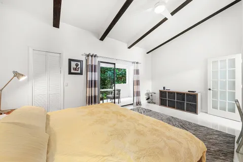 a bedroom with a large bed and a large window