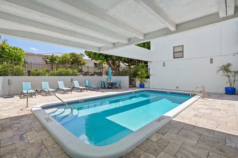 a view of a kitchen with furniture and floor to ceiling window