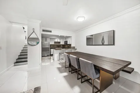 a workspace with wooden floor and white walls