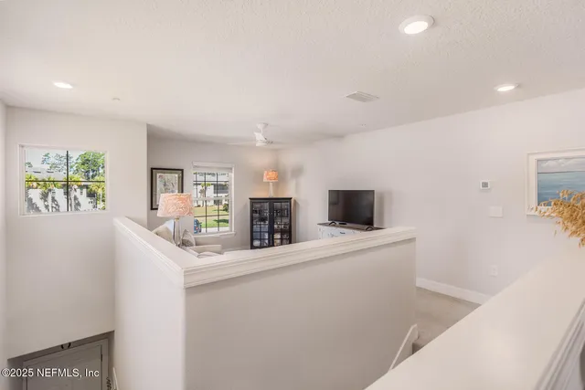 a kitchen with stainless steel appliances a microwave a stove and white cabinets