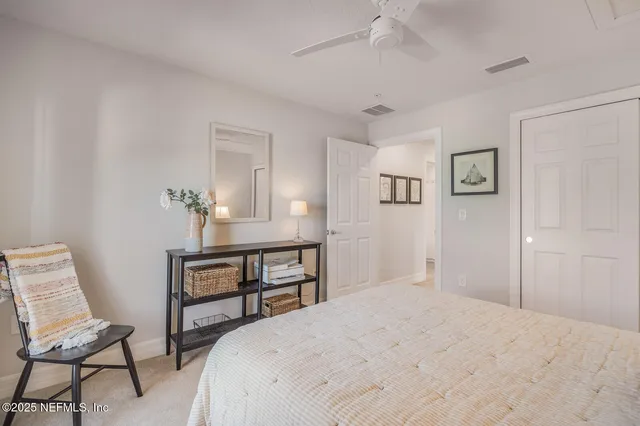 a bedroom with a bed and a chair