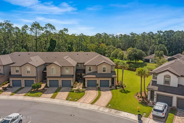 an aerial view of a house with a big yard